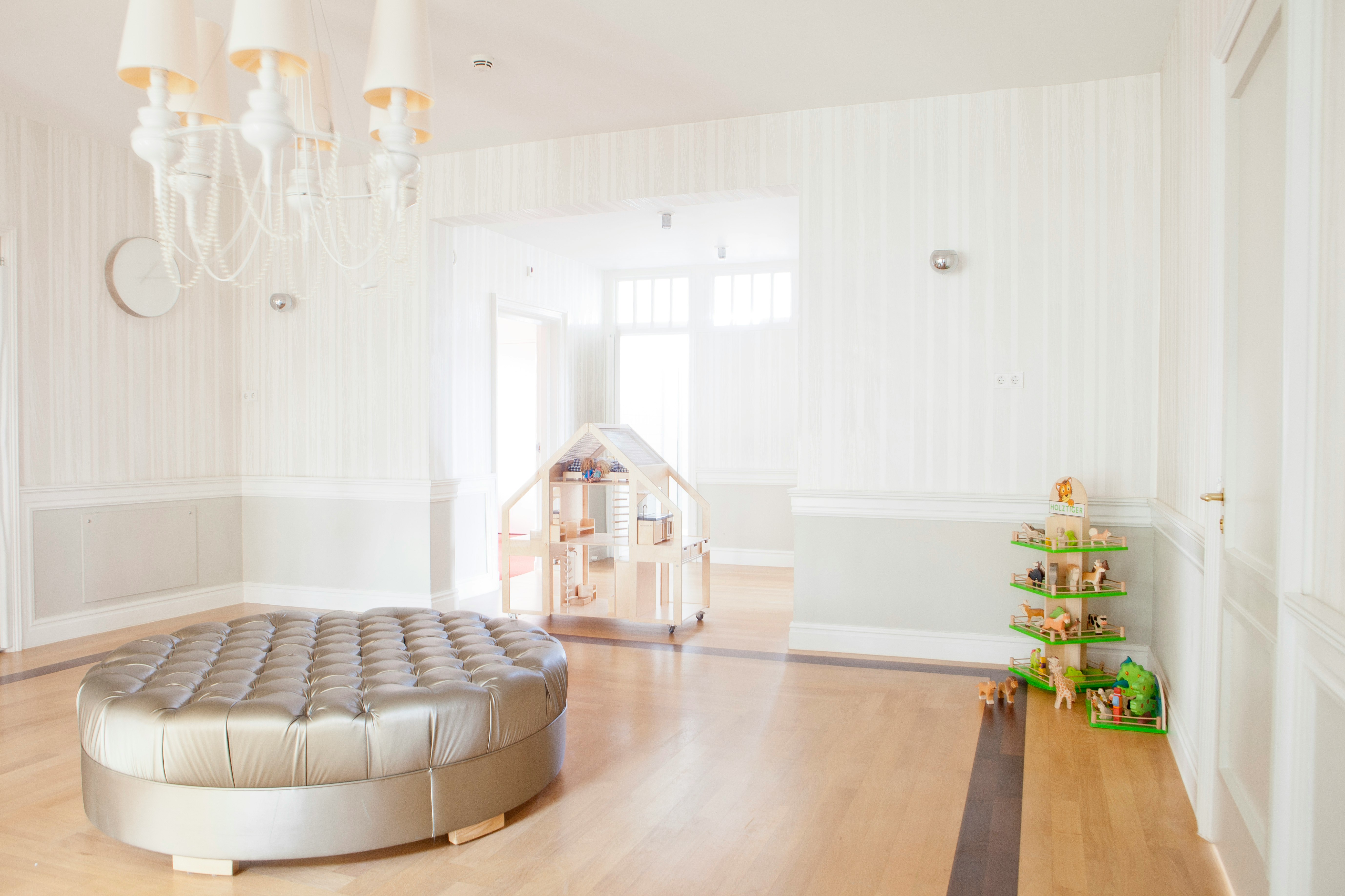 round bed in middle of room with chandelier